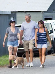 BOAT TRAINING:  Lizzy walking with the adopters and Minipants on a leash.