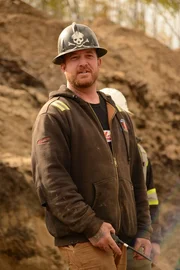 Rick Ness holding a radio mic.