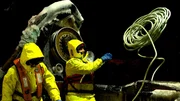 Deck Boss DJ Campbell throws the lines on an opies pot aboard the Cornelia Marie at night.