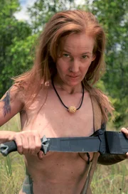 Alana smiles at camera holding her machete. Alana smiles at camera holding her machete.