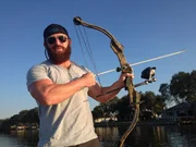 Eric Young holding an arc.