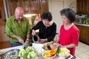 Host Andrew Zimmern cooking with Sally Chow and Alice Chow in Clarksdale MS.