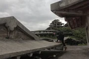 Nakagusuku, Okinawa: RJ exploring, on the roof of the 'haunted' hotel. This hotel is located on a hill, adjacent to the Nakagusuku Castle. It is an abandoned location which was meant to be constructed into a hotel, but was abandoned due to rumors of it being haunted.