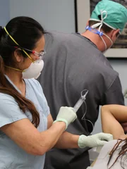 Dr. Lee shows Krista a needle.