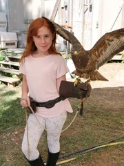 Piper, the daughter of Wild Skies Live directors Shannon and Rob, holds a bird as it flutters its wings. Piper, the daughter of Wild Skies Live directors Shannon and Rob, holds a bird as it flutters its wings.