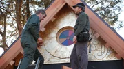 Two men working on the stained glass window.