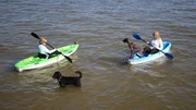 Contributor Kristin Dukes (L) and her daughter Haley Carter (R) enjoy an afternoon kayaking in Mobile Bay, Alabama with their dogs, as seen on HGTV's Beachfront Bargain Hunt.