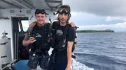 L-R: Sam and Parker posing on the boat in diving gear
