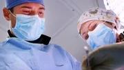 Dr. Brad performing surgery with crew