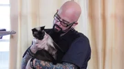 Jackson Galaxy holds Precious the cat. Jackson Galaxy holds Precious the cat.