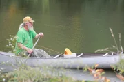 A fisherman canoeing in Alligator alley. A fisherman canoeing in Alligator alley.