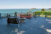 From the comfort of the back deck, the Ocean Bluff House overlooks the ocean, as seen on HGTV's Beach Hunters.