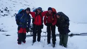 Parker Schnabel, Rick Ness, Karla Charlton & James Levelle on the Chilkoot Trail stand outside.