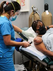 Dr. Lee operates on Stacey’s arm. Dr. Lee operates on Stacey’s arm.