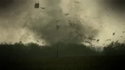 An early tornado devastates a house and kicks up debris in Bowling Green, Missouri; image shows house and debris.