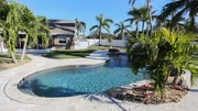 The large backyard and pool at the Bayshore House in Cocoa Beach, Florida, as seen on HGTV's Beach Hunters.