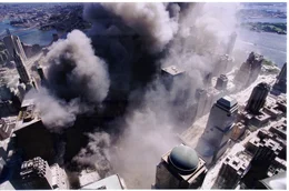 PUBLIC DOMAIN from National Institute of Science and Technology.  Just after the North Tower collapsed, an aerial photograph captures a black, acrid smoke cloud as it consumes Lower Manhattan.