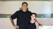 Kamohai and Tristyn stand in their freshly demo'd kitchen in their first flip in Kona, as seen on Renovation Aloha, Season 2.