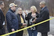Hope‚Äôs family with Detective Burns talk with Detective Burns behind police tape