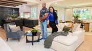 Husband and wife duo, Mike Jackson and Egypt Sherrod, pose together in the newly renovated Jeske living room in Atlanta, Georgia, as seen on Married to Real Estate, Season 3.