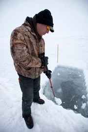 Vince Skiba finishes digging a hole in the Bering Sea ice.