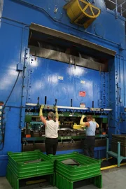The workers keep their hands in a safe place while the 1 tonne press shapes pieces of steel for the combine. The workers keep their hands in a safe place while the 1 tonne press shapes pieces of steel for the combine.