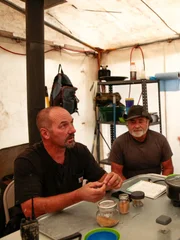 L-R: Dave Turin and Jesse Goins talking in gold room