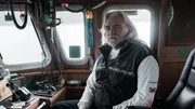 Summer Bay Captain Wild Bill poses towards the camera in the wheelhouse.