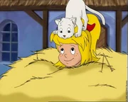 Bibi ist mit ihrem Hexenbesen versehentlich mitten in einem Heuwagen gelandet. Bibi ist mit ihrem Hexenbesen versehentlich mitten in einem Heuwagen gelandet.