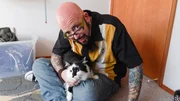 Jackson Galaxy looks ahead while holding Lux the cat.