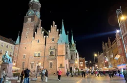 Wer Wrocław verstehen will, steigt in die Stra&szlig;enbahnlinie 1. Seit 140 Jahren rollt sie durch die Stadt &ndash; eine der &auml;ltesten noch betriebenen Tramlinien Europas. Nach dem Krieg war sie die erste, die wieder fuhr: durch Tr&uuml;mmer, Hoffnung und einen Neuanfang. Heute f&uuml;hrt sie an renovierten Fassaden und gr&uuml;nen Oder-Ufern zu den Wohnbl&ouml;cken der Moderne. - Die Altstadt von Wrocław am Abend.