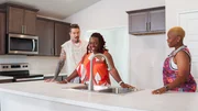 From left to right: Host David Bromstad, Charman Morgan-Davis, and Morgan Davis explore the kitchen of House 3, Queen's Landing, as seen on My Lottery Dream Home, Season 17. From left to right: Host David Bromstad, Charman Morgan-Davis, and Morgan Davis explore the kitchen of House 3, Queen's Landing, as seen on My Lottery Dream Home, Season 17.
