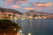 summer fun city of Saranda in Albania at sunset with all lights flashing with hotels lining along sea front summer fun city of Saranda in Albania at sunset with all lights flashing with hotels lining along sea front