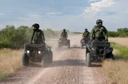Laredo, TX: Customs and Border Protection agents patrolling the border on ATVs. Laredo, TX: Customs and Border Protection agents patrolling the border on ATVs.