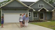 Family meeting realtor in front of house