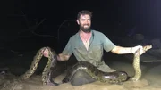 Forrest Galante Sitting In The Mud With The Anaconda.