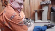 Cat owner Allan holds Barnabas the cat. Cat owner Allan holds Barnabas the cat.