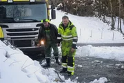 Odda, Norway - (Left to Right) Jarle Hauksland and Thord Paulsen. Jarle Hauksland is a local guy helping Thord to rescue the trash truck that has one of the wheels in the ditch. They are planning how to do the operation.