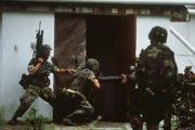 American soldiers search houses for possible enemies on the second day of the US invasion of Grenada. | Location: Grenada Island.