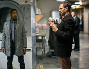 "Dirty Laundry"-- Sherlock (Jonny Lee Miller, right) and Detective Bell (Jon Michael Hill, left) investigate the murder of the general manager of a high end Manhattan hotel whose body is found inside an industrial laundry machine, on ELEMENTARY.