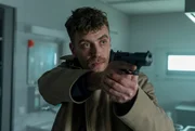 Nils Sanchez (Enrique Fiß) bewegt sich mit Waffe im Angschlag durch die Klinik.