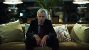John Hamilton sitting on a couch.