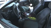 Board guard is searching a car on board.