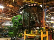 The cab of the combine, ready to be hoisted into place on the main assembly line. The cab of the combine, ready to be hoisted into place on the main assembly line.