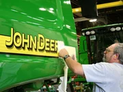 The decals are put on the side of the combine by skilled and careful hands. The decals are put on the side of the combine by skilled and careful hands.