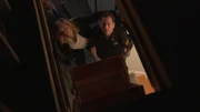 Poulk and officer looking up at the attic.