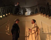 An investigator interrupts Lt. Col. Recordon (played by Mario Hermeto) - he has found a suitcase belonging to Touvier.