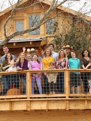 People on the porch of the finished treehouse.