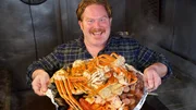Host Casey Webb in Savannah, Georgia with The Crab Shack's Captain Crab Sampler Platter.