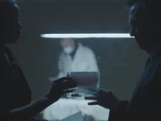 Close up on bracelet in evidence bag, passed between detectives.